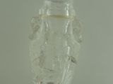 a clear glass vase with a black base on a table