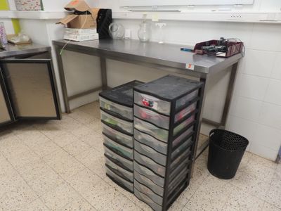 a metal table with a bunch of drawers on it