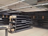 a large empty store with empty shelves in the middle of the room