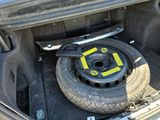 a tire in the trunk of a car with a tire wren