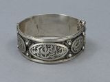 a close up of a silver ring on a gray surface
