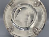 two silver plate with lion heads on each side and a silver plate with lion heads on the other side