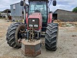a tractor that is parked in the dirt