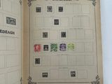 an open book with stamps on it on a white surface