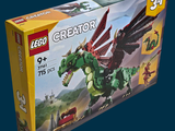 a box of lego creators with a green dragon on it