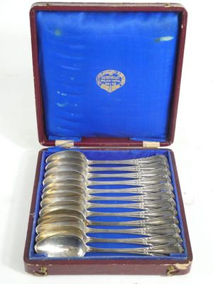 silverware in a case with a blue cover and a red handle