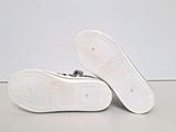 the bottom of a pair of white shoes on a white surface