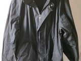 jacket hanging on a hanger on a white wall in a room