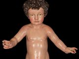 a small doll of a boy with a curly hair