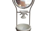 a mirror on a stand with a bowl and a bowl on it