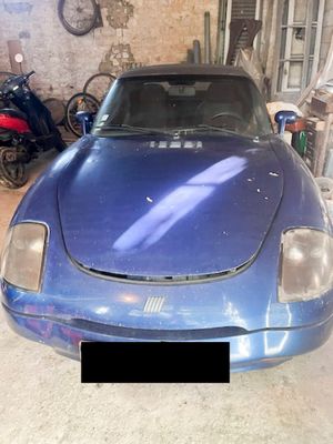 a picture of a blue sports car in a garage