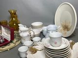 a lot of dishes and cups on the table