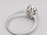 a close up of a diamond ring on a white surface