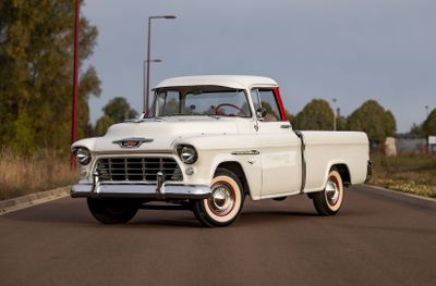 a white truck that is driving down the street