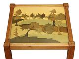 a small table with a painting on the top