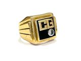 an image of a gold ring with a black and white logo on it