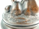 a silver statue of a dog on a pedestal