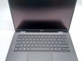 an open laptop computer sitting on top of a white table