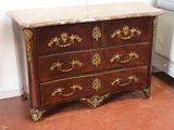 a marble top chest of drawers in the corner of a room