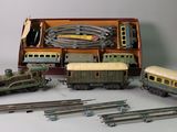 several toy trains are lined up in a box on a white surface