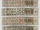 a close up of a group of playing cards on a white surface