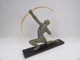 bronze sculpture of a man holding an arrow on a wooden base