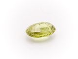 a yellow sapphire stone on a white background