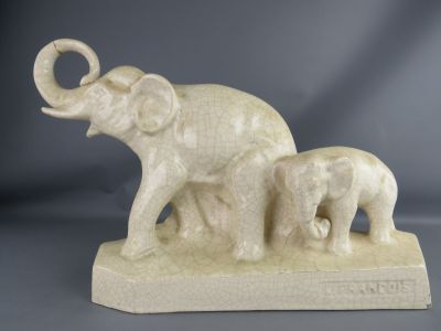 a statue of an elephant and a baby elephant on a base