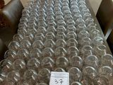 bottles of wine are lined up on a table in a room