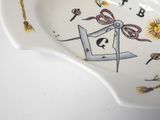 a white bowl with a clock on it and a drawing on the side