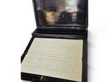 a black box with a white paper inside of it