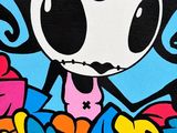 graffiti art of a cartoon girl holding a bunch of flowers on a wall