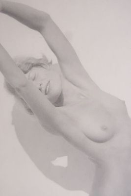 black and white photograph of a nude woman in a bathtub