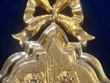 a gold locke with a bow on top of it