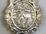 a silver plate with a picture of a man and a woman on it
