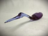 a glass spoon with a spoon rest on a table
