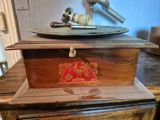 a wooden box on top of a table with a plate on it