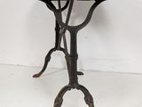 wrought iron table with a marble top on a white background