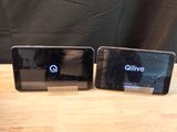 two cell phones sitting next to each other on a table