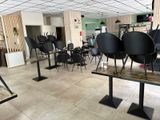 many chairs and tables in a room with tile flooring