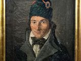 portrait of a man in a blue hat and coat with a bow tie