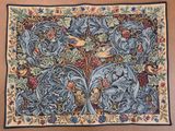 a tapestry with birds and flowers on a brown background