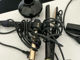 a hair dryer, a hair dryer, and a charger sitting on a table
