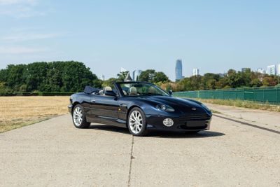 a black convertible car parked on the side of the road