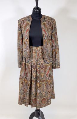 an image of a dress and jacket on a mannequin stand