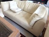 a large white couch in the middle of a living room