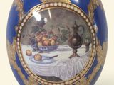a blue and gold egg with a picture on it