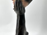 a statue of a man holding his hand to his face