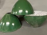 three green bowls sitting on a table with a clock in the background