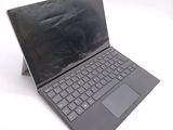 a laptop that is open on a white surface